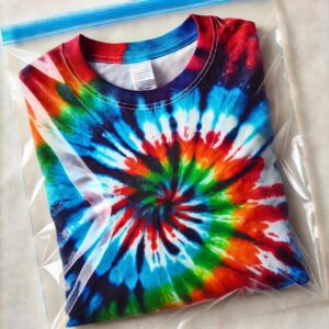 “Setting the Tie-Dye Colors – Plastic Bag Method”
A freshly dyed tie-dye t-shirt sealed inside a plastic bag to let the colors set for 6-8 hours.
